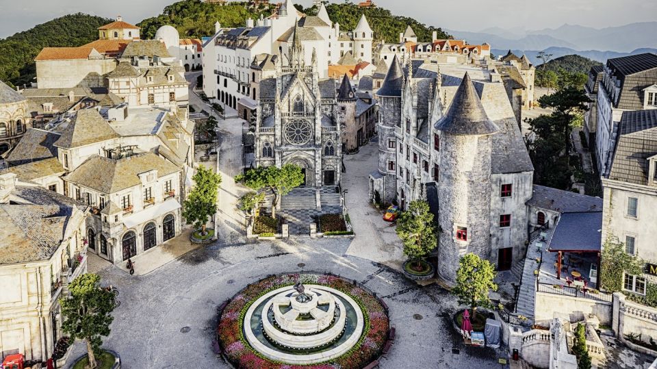 From Da Nang: Ba Na Hills Golden Bridge Day Tour & Lunch - French Village: lunch buffet, stone church, and festival energy